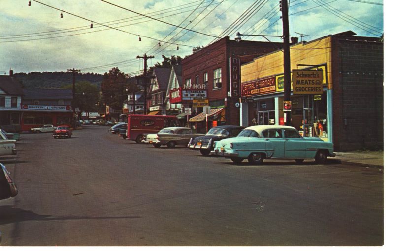 A historic photograph of Main Street in Livingston Manor, New York, from 1958, with a 1957 Pontiac parked along the street